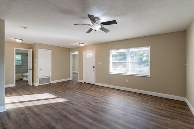 interior space featuring ceiling fan, a textured ceiling, and dark hardwood / wood-style floors