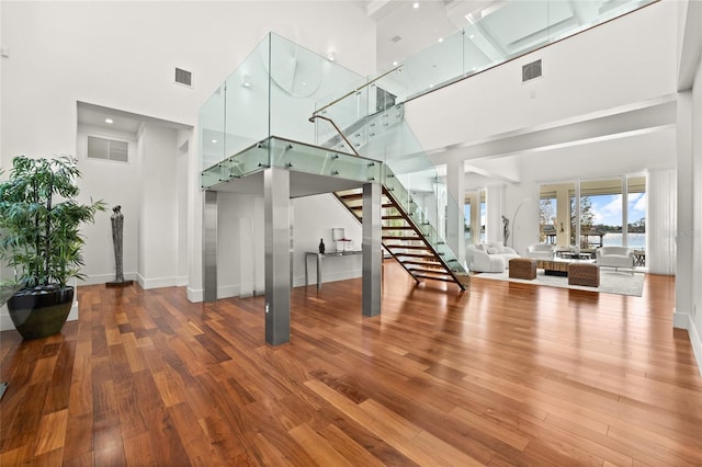 living room featuring hardwood / wood-style floors and a high ceiling