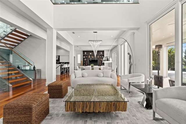 living room with a chandelier and light wood-type flooring