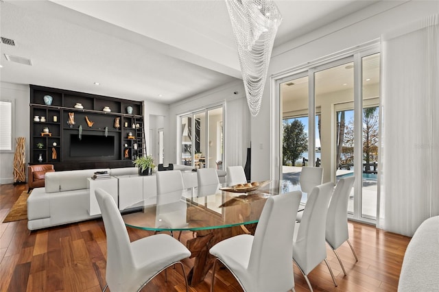 dining space featuring an inviting chandelier and wood-type flooring