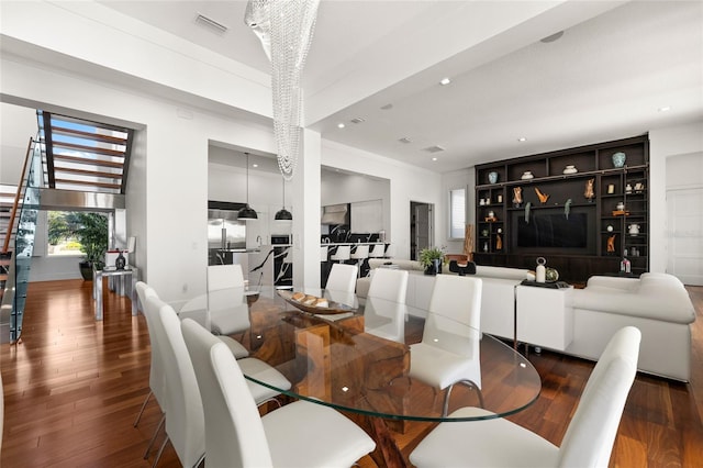 dining area featuring dark wood-type flooring and built in shelves