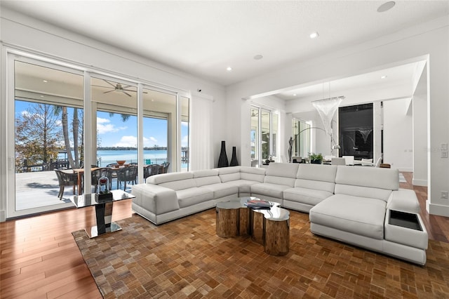 living room featuring hardwood / wood-style flooring and a water view