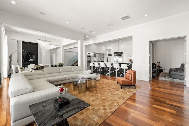 living room with crown molding and hardwood / wood-style flooring