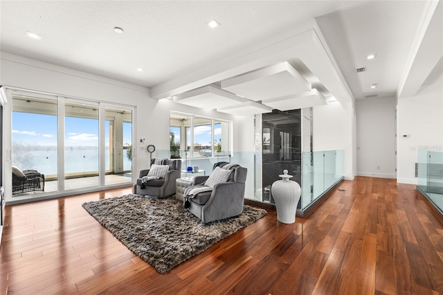 living room with wood-type flooring and a water view