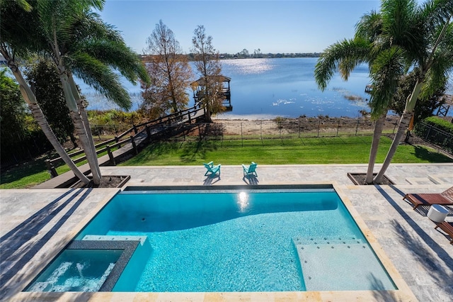 view of swimming pool with a water view, a yard, and a patio area