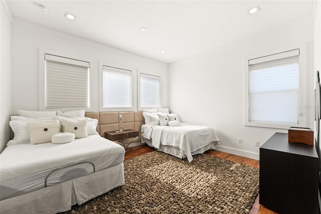 bedroom with wood-type flooring and ornamental molding