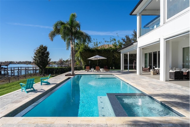 view of pool featuring a water view, ceiling fan, outdoor lounge area, and a patio area