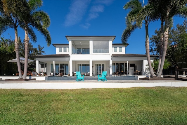 back of house with a patio area and a lawn