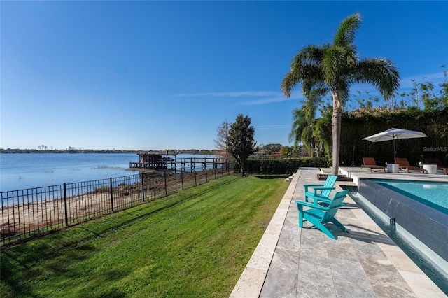 view of pool featuring a water view, a patio area, and a lawn