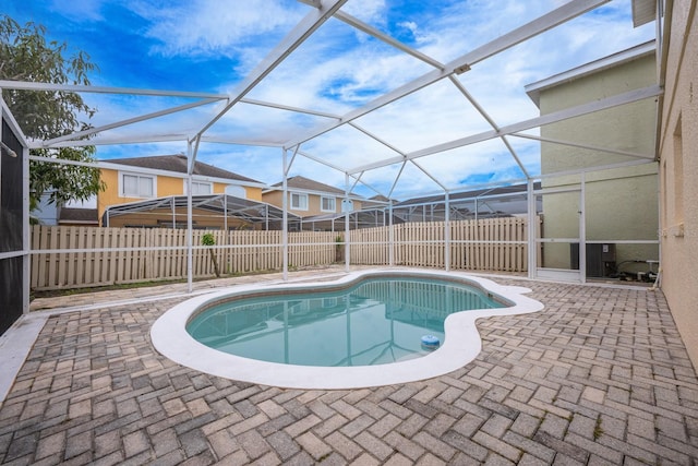 view of pool featuring a lanai and a patio