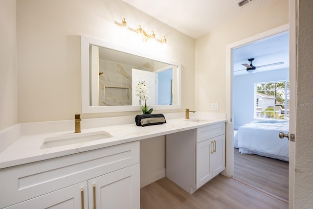 bathroom with ceiling fan, hardwood / wood-style floors, and vanity