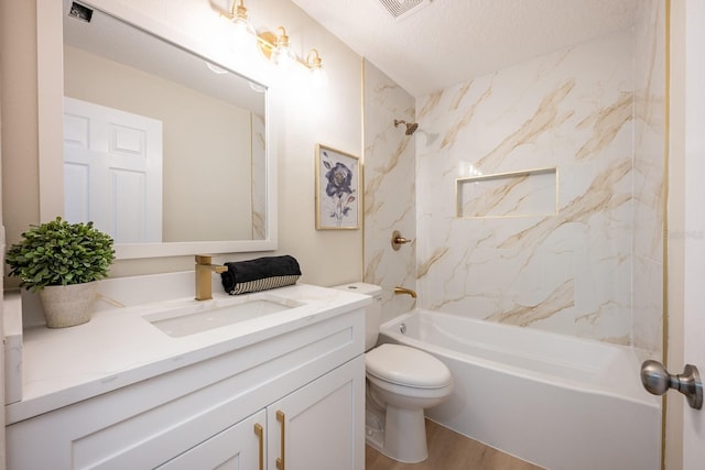 full bathroom with a textured ceiling, tiled shower / bath, vanity, toilet, and hardwood / wood-style flooring