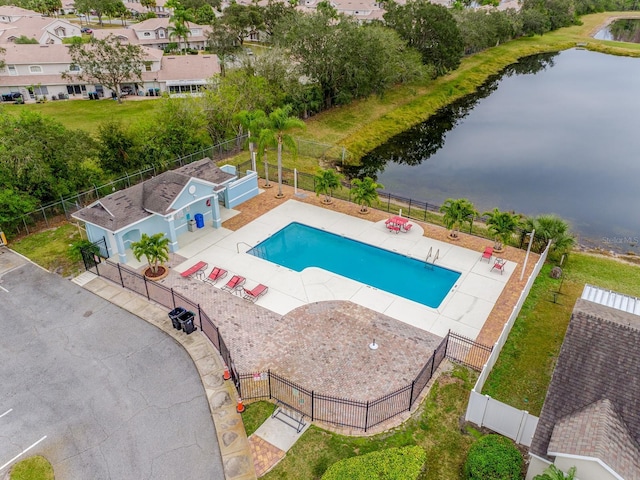 view of pool featuring a water view and a patio