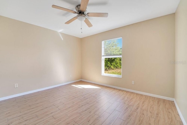 spare room with light hardwood / wood-style floors and ceiling fan