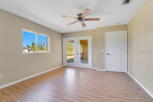 spare room featuring french doors, light hardwood / wood-style floors, and ceiling fan