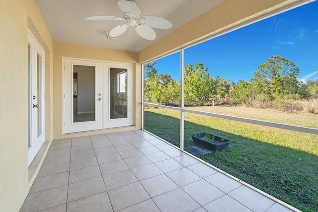 unfurnished sunroom featuring french doors and ceiling fan