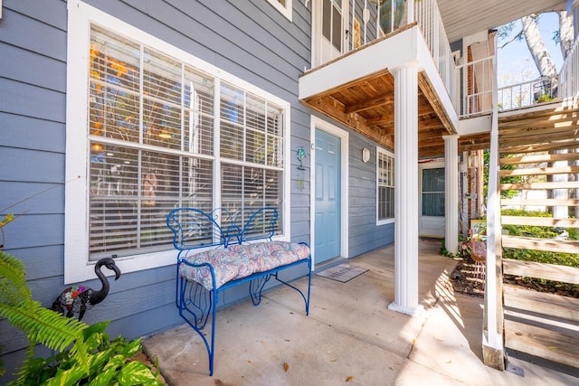 view of patio with a balcony and a porch