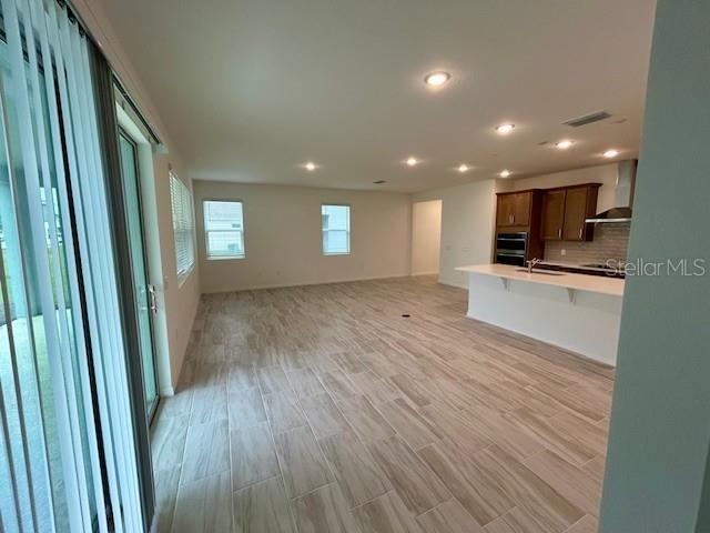 unfurnished living room featuring light hardwood / wood-style floors