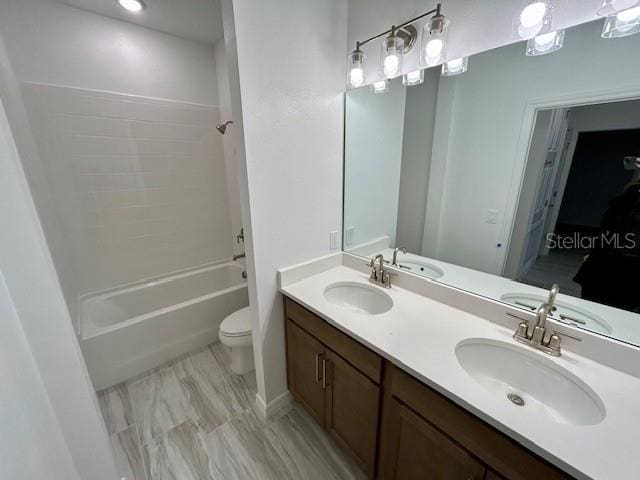 full bathroom featuring toilet, shower / washtub combination, and vanity