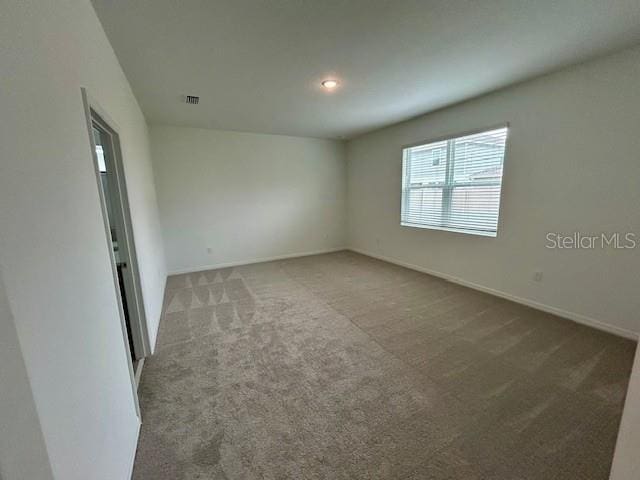 unfurnished room with carpet flooring