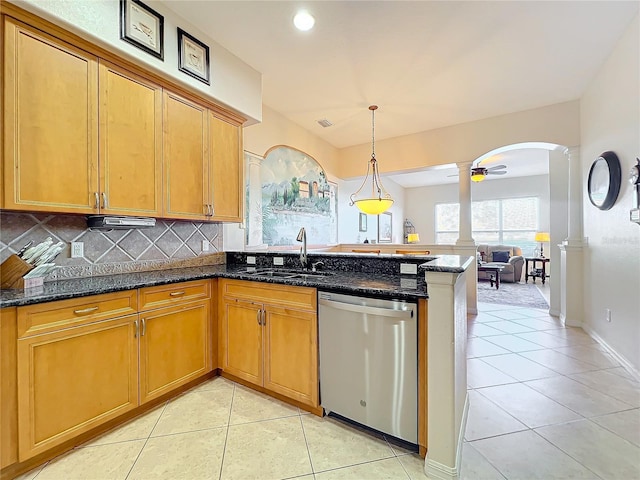 kitchen with sink, stainless steel dishwasher, ceiling fan, dark stone countertops, and tasteful backsplash