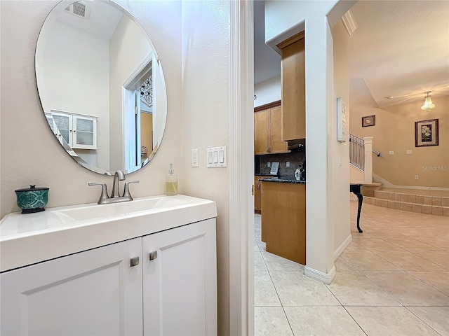 bathroom with tile patterned flooring, vanity, and backsplash