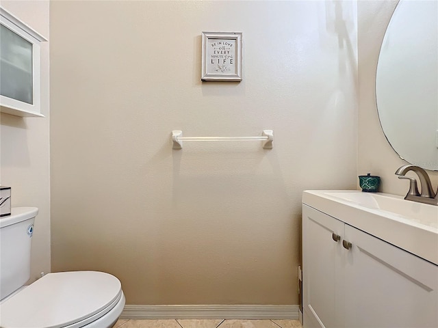 bathroom featuring tile patterned floors, vanity, and toilet