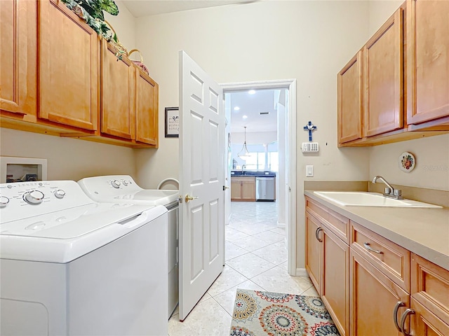 washroom featuring cabinets, independent washer and dryer, light tile patterned floors, and sink