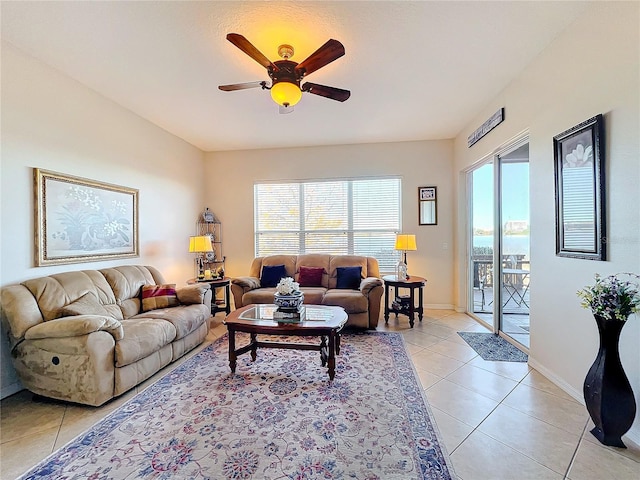 tiled living room featuring ceiling fan and a wealth of natural light