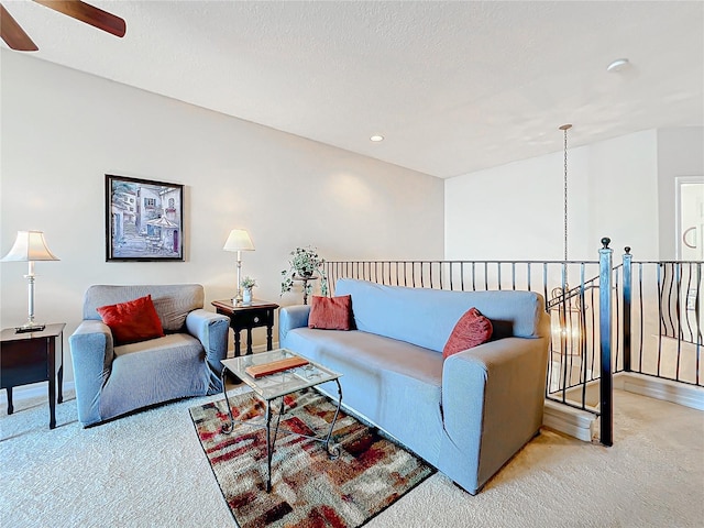 carpeted living room featuring ceiling fan