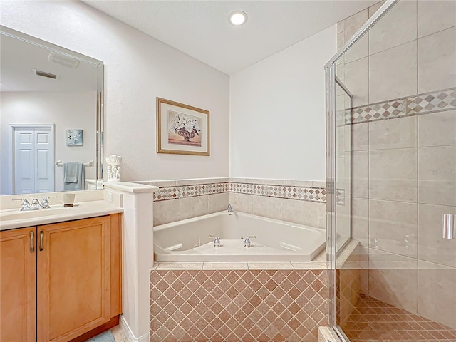 bathroom with vanity and independent shower and bath