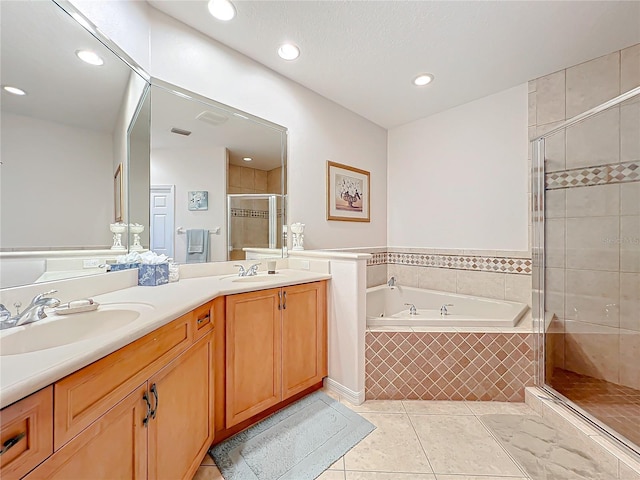 bathroom with tile patterned floors, vanity, and shower with separate bathtub