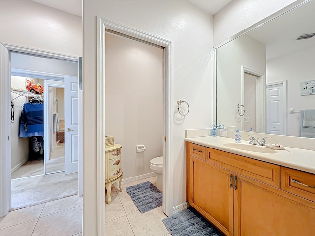 bathroom with tile patterned flooring, vanity, and toilet