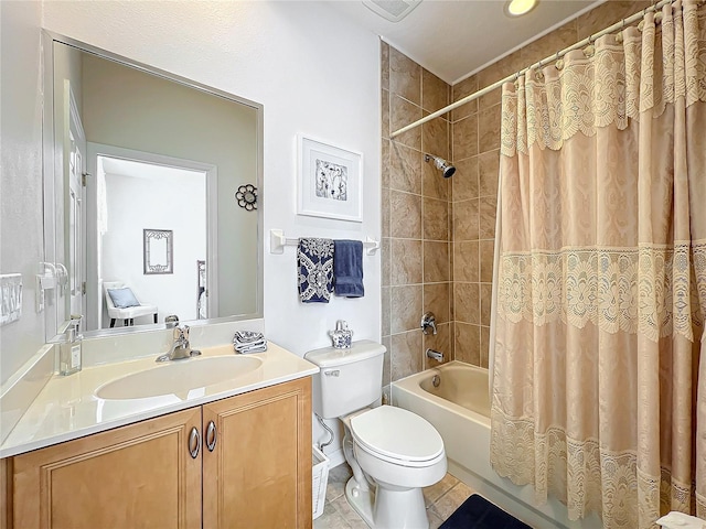 full bathroom with tile patterned flooring, shower / bath combination with curtain, vanity, and toilet