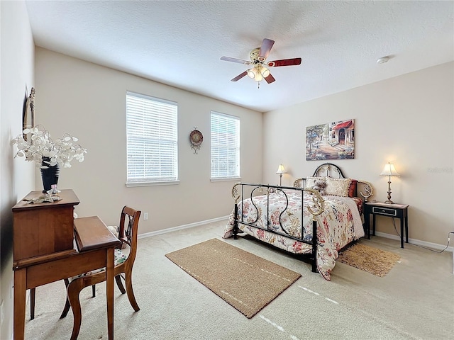 carpeted bedroom with a textured ceiling and ceiling fan