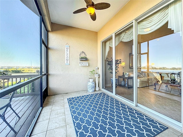 sunroom featuring ceiling fan and plenty of natural light