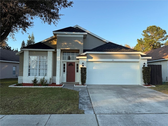 view of front of property featuring a garage and a front lawn