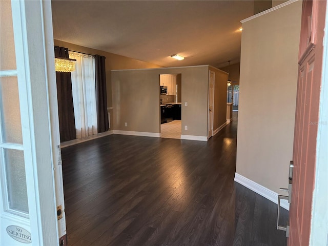 unfurnished living room featuring lofted ceiling and dark wood-type flooring