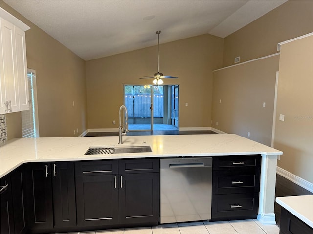 kitchen with stainless steel dishwasher, ceiling fan, sink, light tile patterned floors, and lofted ceiling