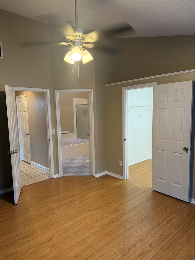 empty room featuring ceiling fan and light hardwood / wood-style flooring