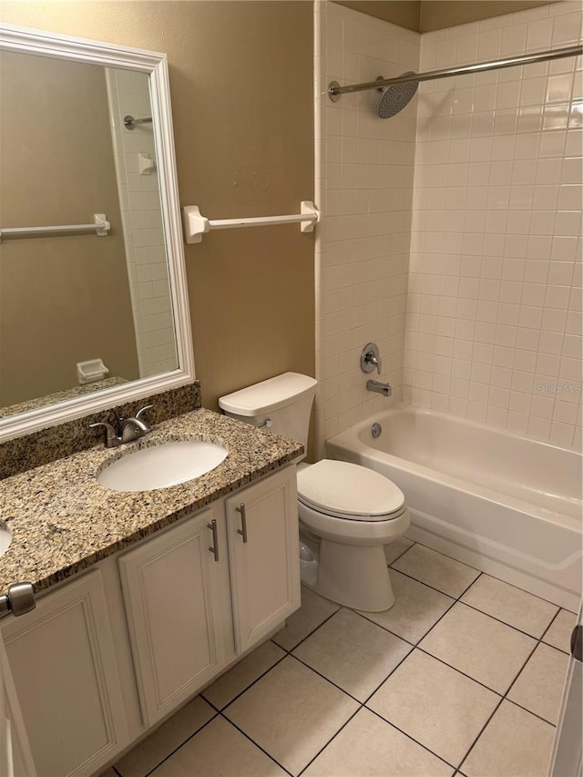 full bathroom with tile patterned flooring, vanity, toilet, and tiled shower / bath