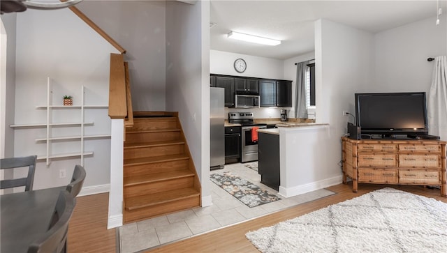 kitchen with light hardwood / wood-style floors and appliances with stainless steel finishes