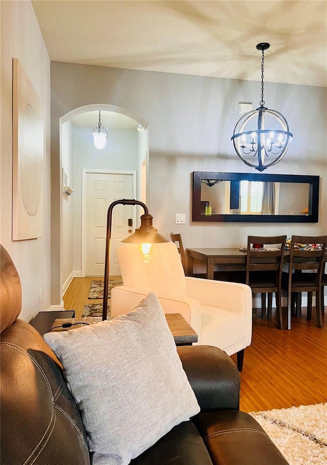 living room with hardwood / wood-style floors and an inviting chandelier