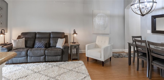 living room with an inviting chandelier and hardwood / wood-style flooring