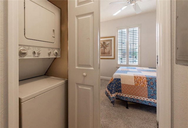 laundry area featuring ceiling fan, carpet flooring, and stacked washer and dryer