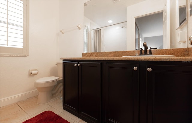 bathroom with walk in shower, vanity, tile patterned floors, and toilet