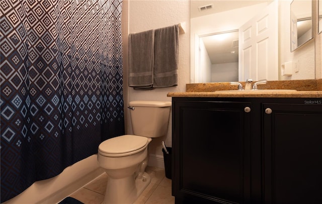 bathroom featuring toilet, tile patterned floors, and vanity