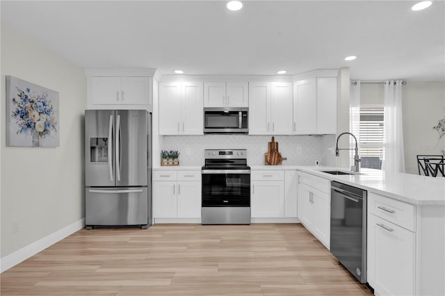 kitchen with white cabinets, backsplash, stainless steel appliances, and sink