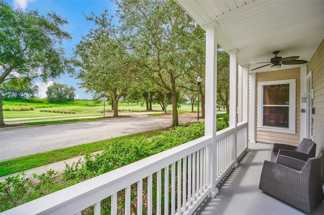 balcony with ceiling fan and a porch