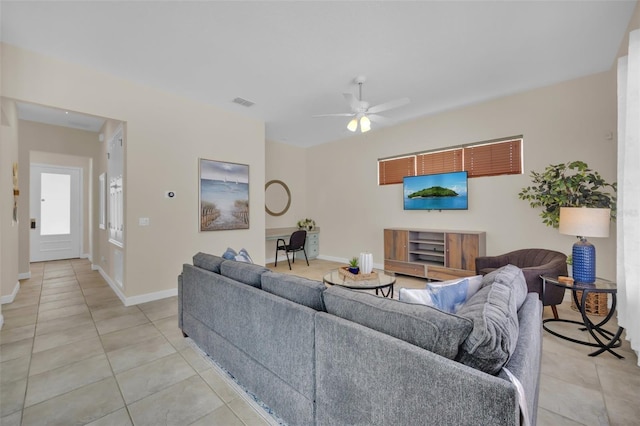 tiled living room with ceiling fan